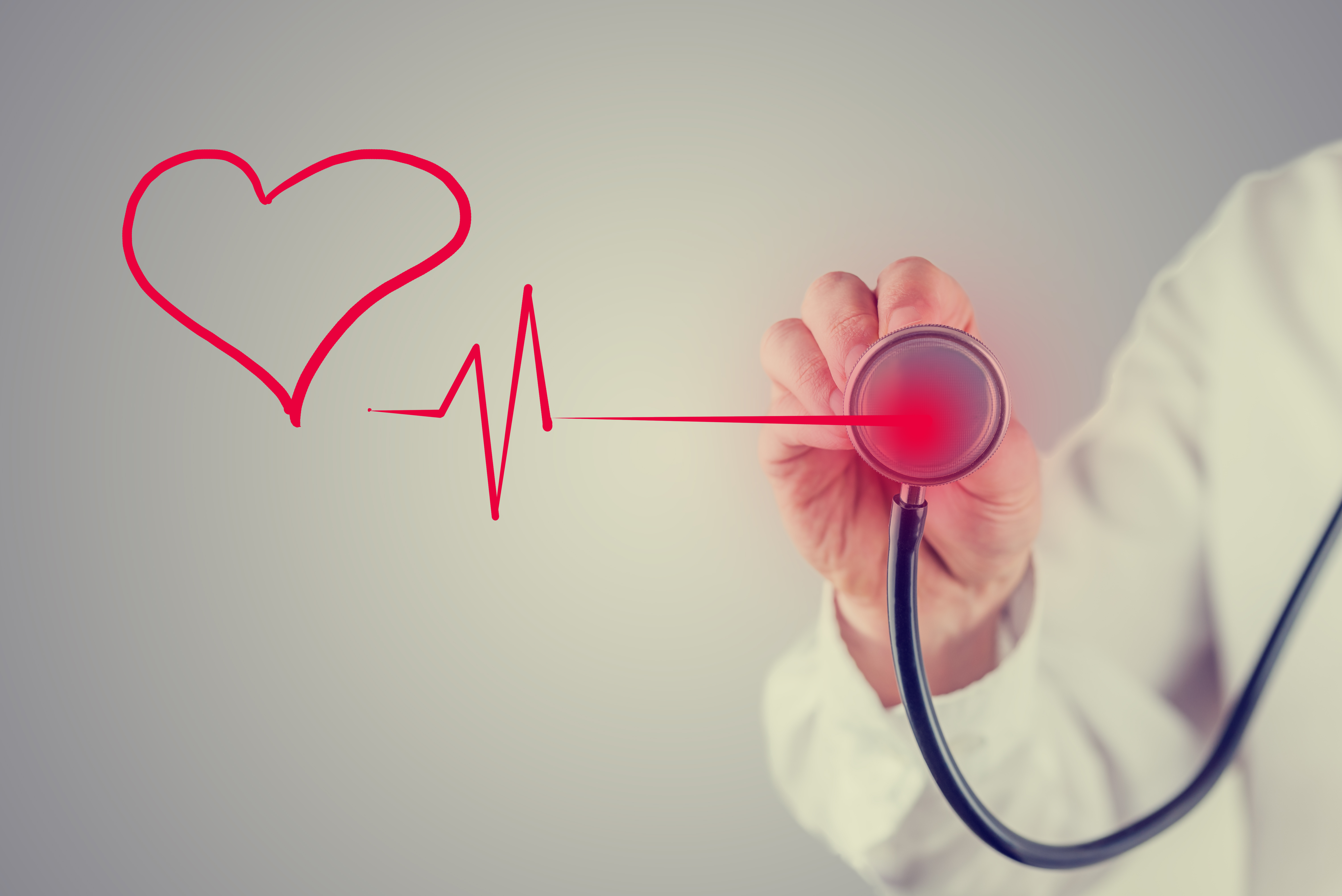 Retro faded effect image of a healthy heart and cardiology concept with a hand-drawn red heart linked to the disc of a stethoscope by a heartbeat tracing as a doctor listens to the sound.
