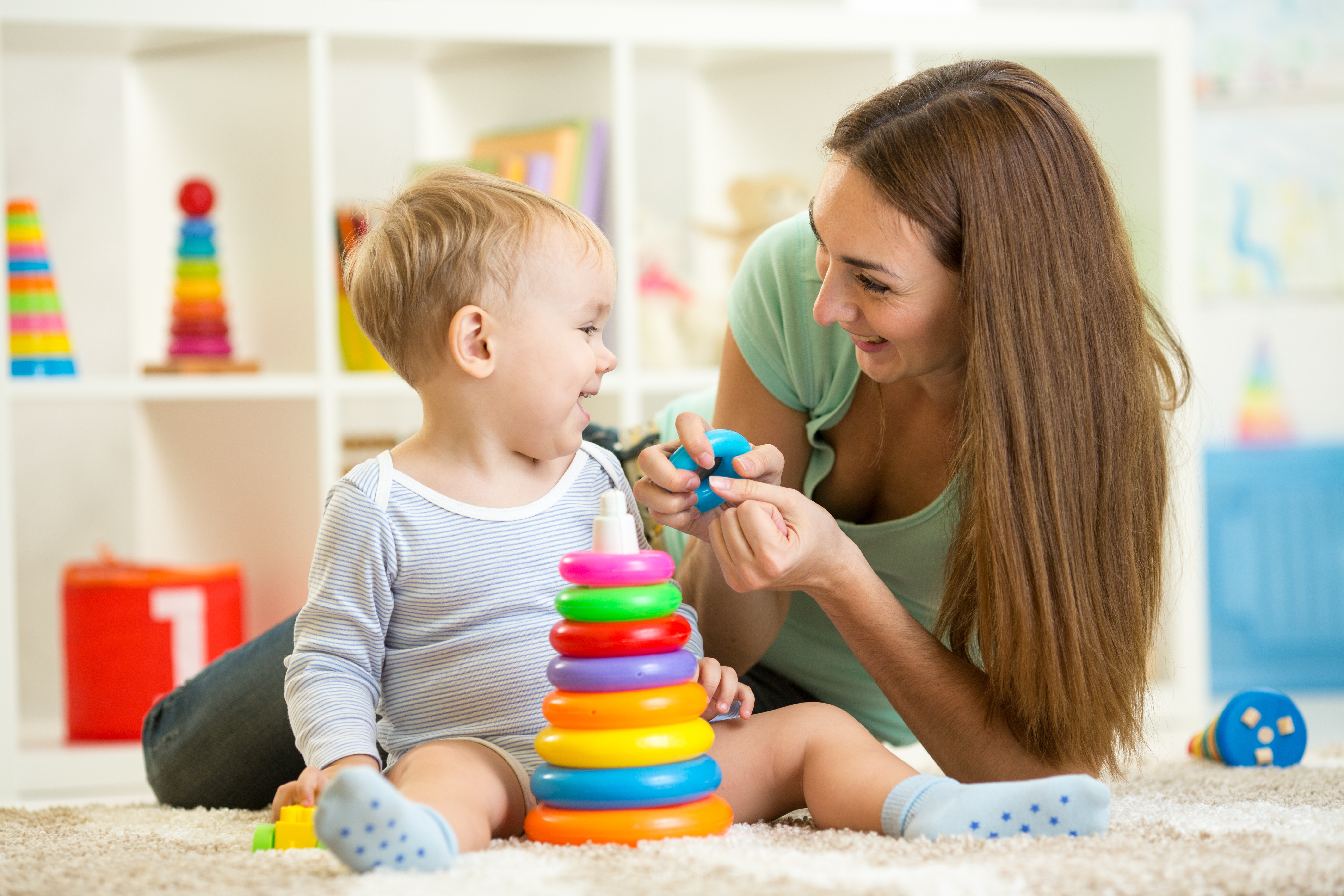 cute mother and child boy play together indoors at home