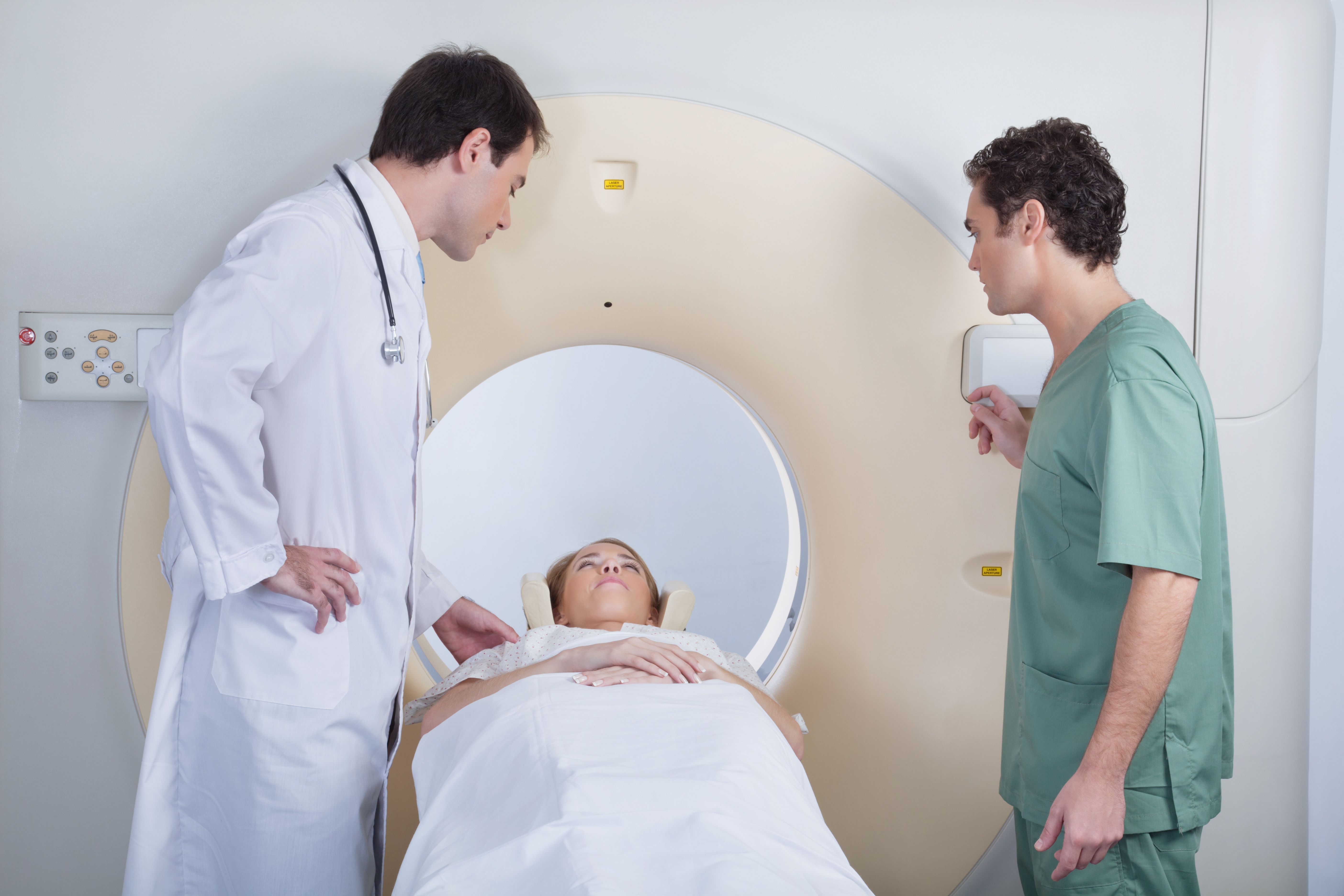 Doctor with technician examining patient before CT scan test