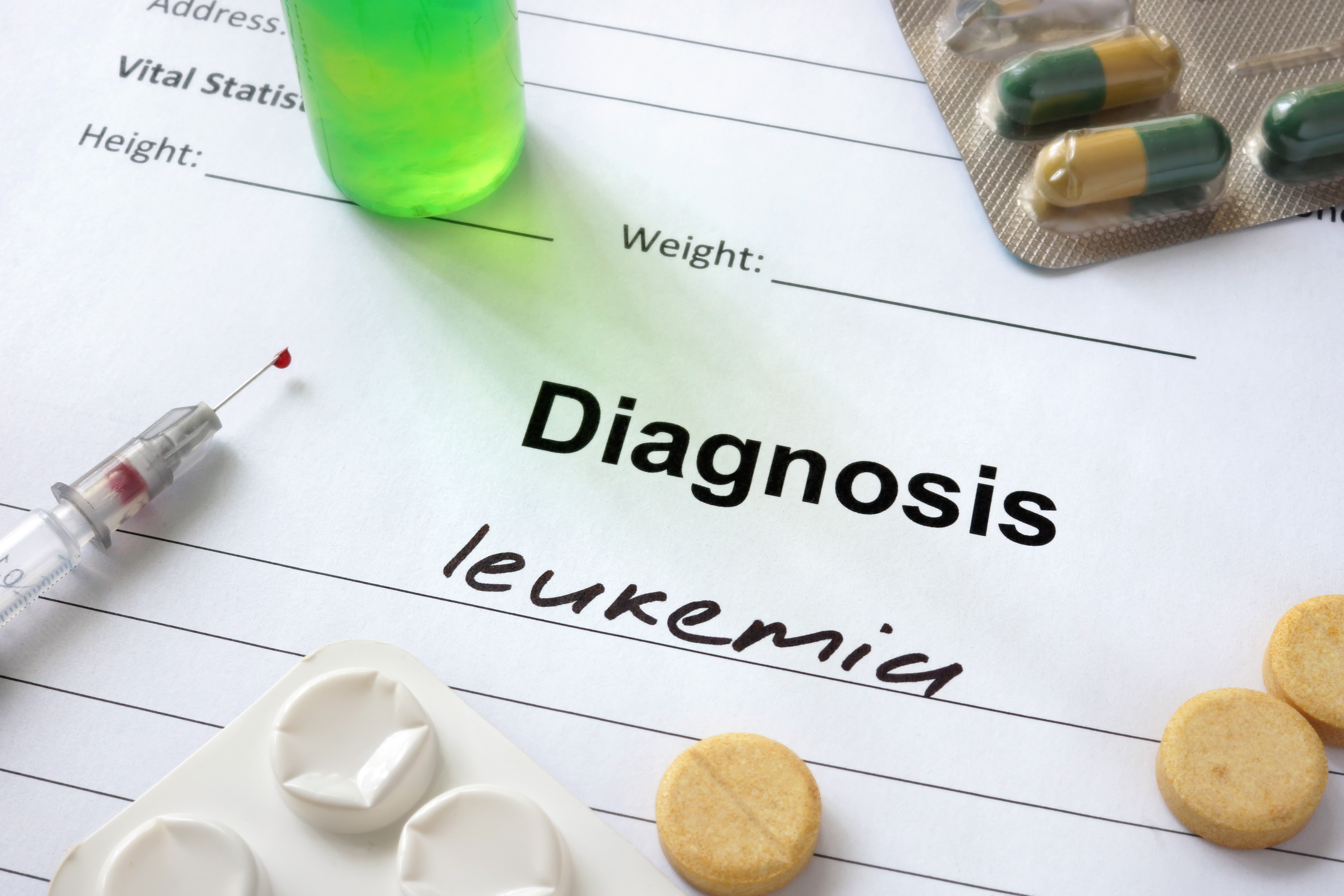 Diagnosis leukemia written in the diagnostic form and pills.