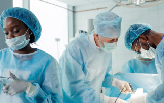 experienced doctors performing organ removal or transplant in the clinic.
