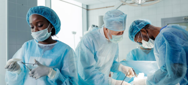 experienced doctors performing organ removal or transplant in the clinic.